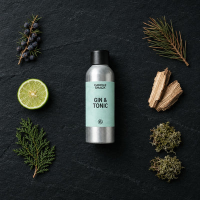 Gin And Tonic fragrance oil - Candle Shack aluminium bottle with dried botanicals on a dark slate background