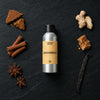 Gingerbread fragrance oil - Candle Shack aluminium bottle with dried botanicals on a dark slate background