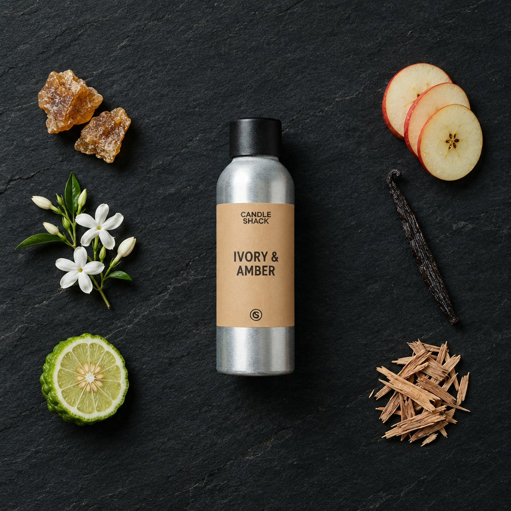 Ivory & Amber fragrance oil - Candle Shack aluminium bottle with dried botanicals on a dark slate background