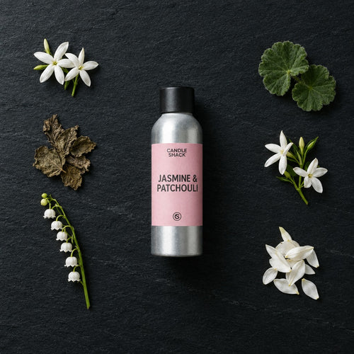 Jasmine & Patchouli fragrance oil - Candle Shack aluminium bottle with dried botanicals on a dark slate background