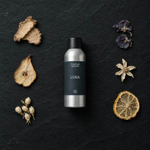 Luna fragrance oil - Candle Shack aluminium bottle with dried botanicals on a dark slate background