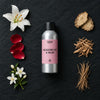 Meadow Lily & Cotton Musk fragrance oil - Candle Shack aluminium bottle with dried botanicals on a dark slate background