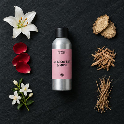 Meadow Lily & Cotton Musk fragrance oil - Candle Shack aluminium bottle with dried botanicals on a dark slate background
