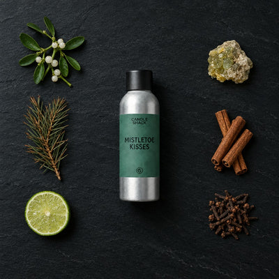 Mistletoe Kisses fragrance oil - Candle Shack aluminium bottle with dried botanicals on a dark slate background