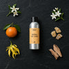 Neroli De Lune fragrance oil - Candle Shack aluminium bottle with dried botanicals on a dark slate background