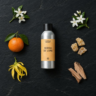 Neroli De Lune fragrance oil - Candle Shack aluminium bottle with dried botanicals on a dark slate background