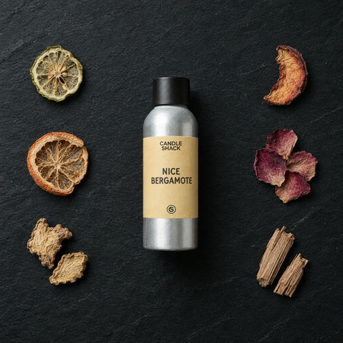 Nice Bergamote fragrance oil - Candle Shack aluminium bottle with dried botanicals on a dark slate background