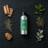 Nordic Cedar fragrance oil - Candle Shack aluminium bottle with dried botanicals on a dark slate background