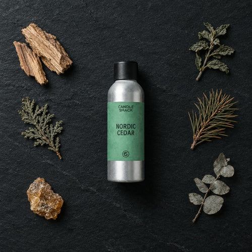 Nordic Cedar fragrance oil - Candle Shack aluminium bottle with dried botanicals on a dark slate background