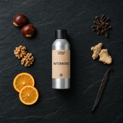 Nutcracker fragrance oil - Candle Shack aluminium bottle with dried botanicals on a dark slate background