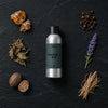 Pandora's Box fragrance oil - Candle Shack aluminium bottle with dried botanicals on a dark slate background