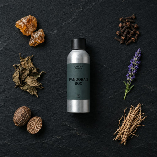 Pandora's Box fragrance oil - Candle Shack aluminium bottle with dried botanicals on a dark slate background