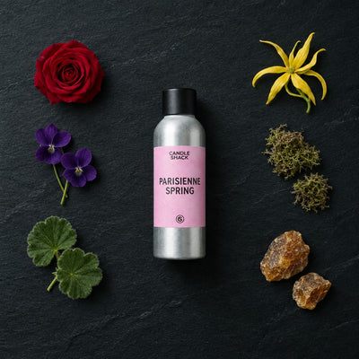 Parisienne Spring fragrance oil - Candle Shack aluminium bottle with dried botanicals on a dark slate background