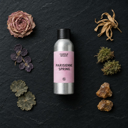 Parisienne Spring fragrance oil - Candle Shack aluminium bottle with dried botanicals on a dark slate background