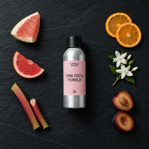 Pink Fizz & Pomelo fragrance oil - Candle Shack aluminium bottle with dried botanicals on a dark slate background
