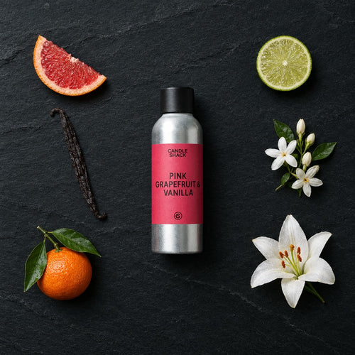 Pink Grapefruit and Vanilla fragrance oil - Candle Shack aluminium bottle with dried botanicals on a dark slate background