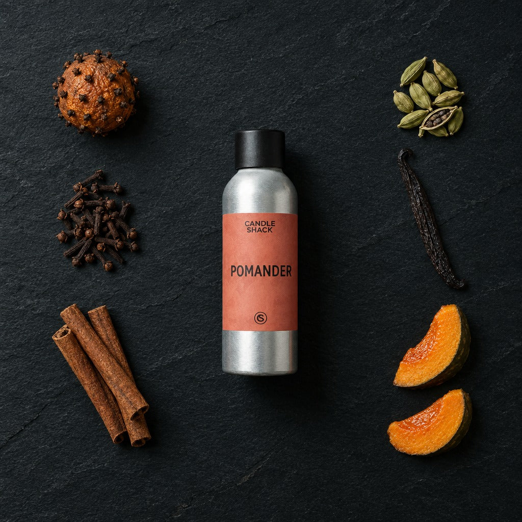 Pomander fragrance oil - Candle Shack aluminium bottle with dried botanicals on a dark slate background