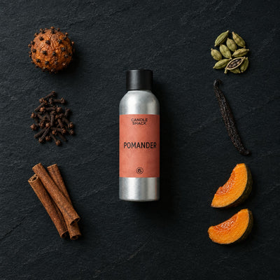 Pomander fragrance oil - Candle Shack aluminium bottle with dried botanicals on a dark slate background