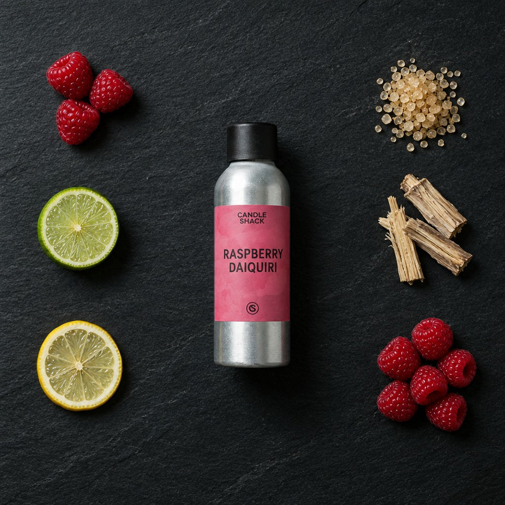 Raspberry Daiquiri fragrance oil - Candle Shack aluminium bottle with dried botanicals on a dark slate background