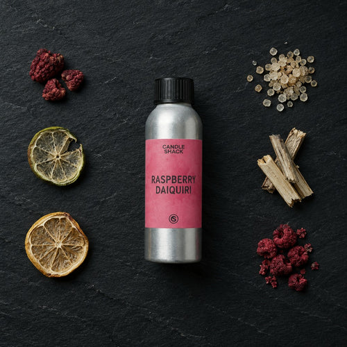 Raspberry Daiquiri fragrance oil - Candle Shack aluminium bottle with dried botanicals on a dark slate background