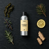 Seaweed and Juniper fragrance oil - Candle Shack aluminium bottle with dried botanicals on a dark slate background