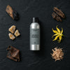 Smoke & Mirrors fragrance oil - Candle Shack aluminium bottle with dried botanicals on a dark slate background