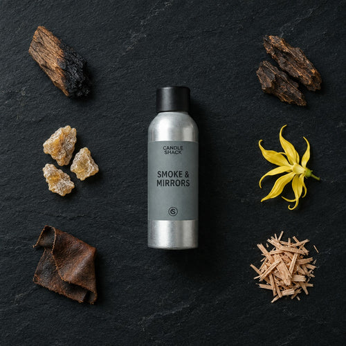 Smoke & Mirrors fragrance oil - Candle Shack aluminium bottle with dried botanicals on a dark slate background