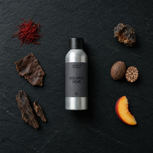 Solaris Noir fragrance oil - Candle Shack aluminium bottle with dried botanicals on a dark slate background