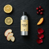 Sparkling Lemon fragrance oil - Candle Shack aluminium bottle with dried botanicals on a dark slate background