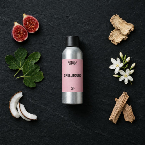 Spellbound fragrance oil - Candle Shack aluminium bottle with dried botanicals on a dark slate background