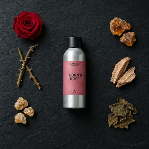 Thorn & Rose fragrance oil - Candle Shack aluminium bottle with dried botanicals on a dark slate background