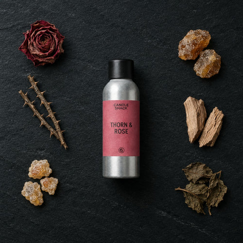 Thorn & Rose fragrance oil - Candle Shack aluminium bottle with dried botanicals on a dark slate background