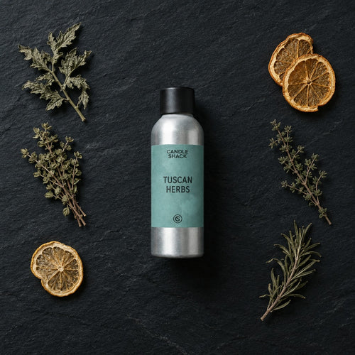 Tuscan Herbs fragrance oil - Candle Shack aluminium bottle with dried botanicals on a dark slate background