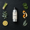 Uplifting Natural Oil fragrance oil - Candle Shack aluminium bottle with dried botanicals on a dark slate background