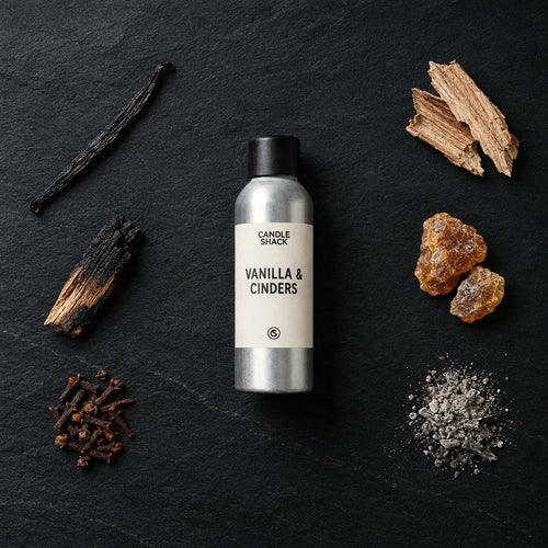 Vanilla & Cinders fragrance oil - Candle Shack aluminium bottle with dried botanicals on a dark slate background
