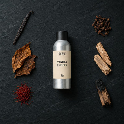 Vanilla Embers fragrance oil - Candle Shack aluminium bottle with dried botanicals on a dark slate background