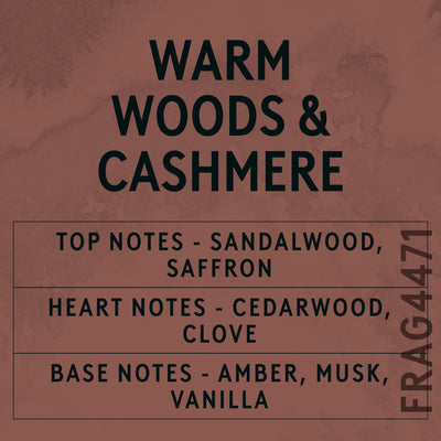 Warm Woods & Cashmere fragrance oil - Candle Shack aluminium bottle with dried botanicals on a dark slate background