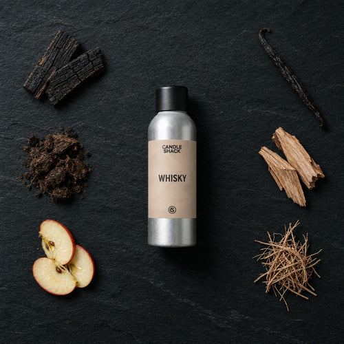 Whisky fragrance oil - Candle Shack aluminium bottle with dried botanicals on a dark slate background