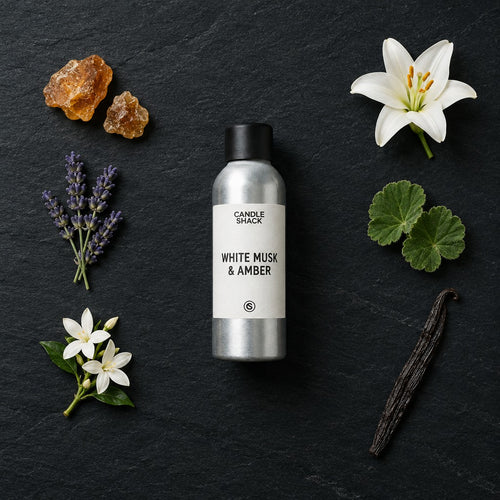 White Musk & Amber fragrance oil - Candle Shack aluminium bottle with dried botanicals on a dark slate background
