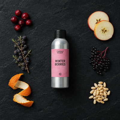 Winter Berries fragrance oil - Candle Shack aluminium bottle with dried botanicals on a dark slate background