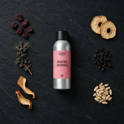 Winter Berries fragrance oil - Candle Shack aluminium bottle with dried botanicals on a dark slate background