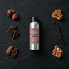Witches Brew fragrance oil - Candle Shack aluminium bottle with dried botanicals on a dark slate background