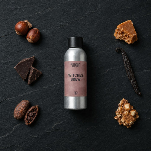 Witches Brew fragrance oil - Candle Shack aluminium bottle with dried botanicals on a dark slate background