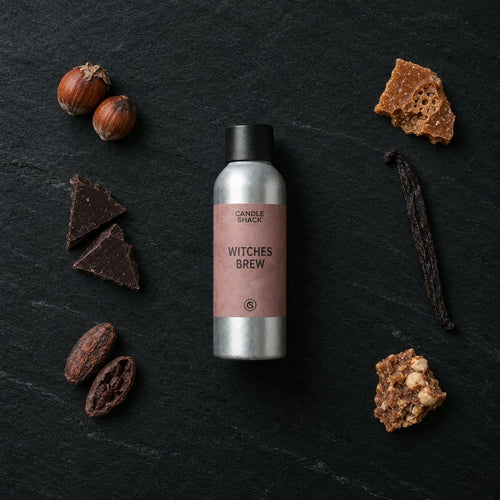 Witches Brew fragrance oil - Candle Shack aluminium bottle with dried botanicals on a dark slate background