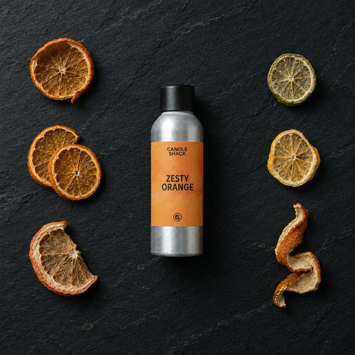 Zesty Orange fragrance oil - Candle Shack aluminium bottle with dried botanicals on a dark slate background